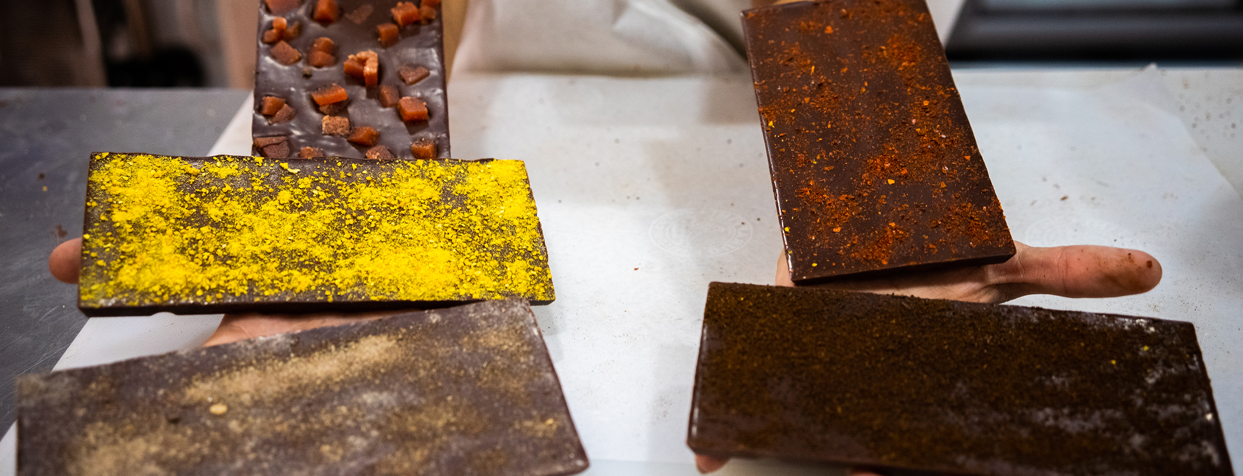 Variety of dark chocolate bars made with premium cacao from Naked Chocolate - Includes flavors like guava, specialty coffee, allspice, red chili pepper, and golden berry